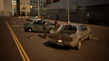 A dusty silver pickup truck is parked on a city street next to a teal car, with two men standing near the teal vehicle in an urban setting.