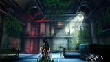 A video game scene showing a female character with long dark hair and glowing green accents standing in a dimly lit industrial interior with vines growing through the walls and beams.