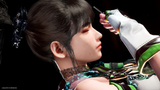 Close-up of a stylized female character in profile with dark hair, wearing a white and green outfit, while a gloved hand holds a small object near her face against a black background.